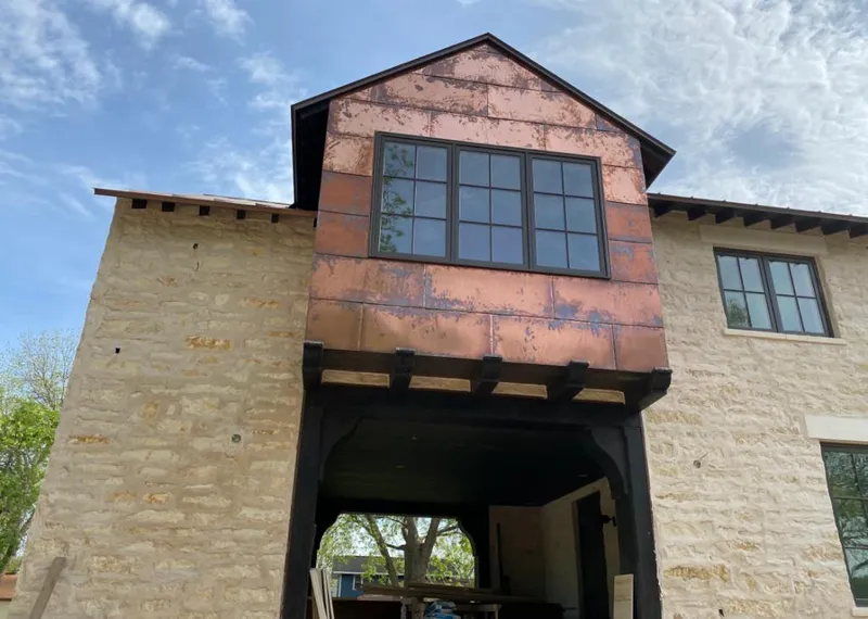 Copper metal panel facade on a stone building for Skylight Installation in Pell City