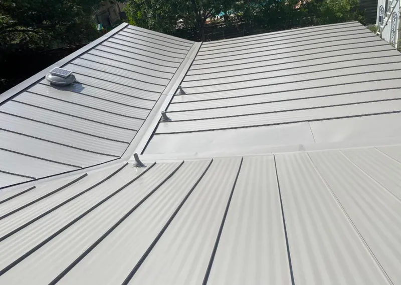 Solar attic fan installed on a metal roof for Roof Ventilation in Pell City